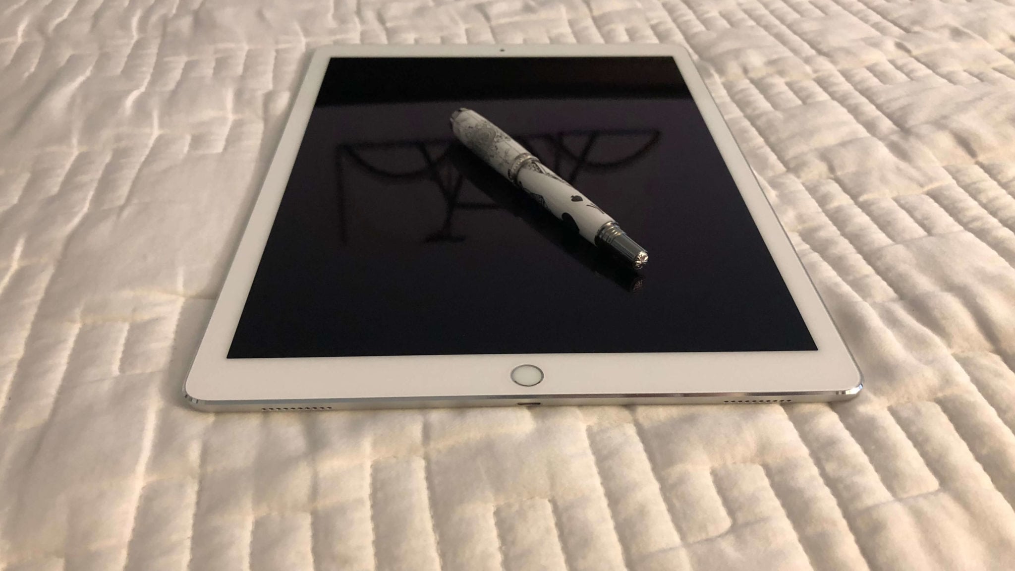 Pen on iPad on bed