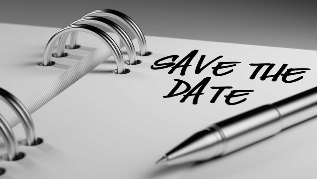 Close up of the words "save the date" written on notebook with pen.