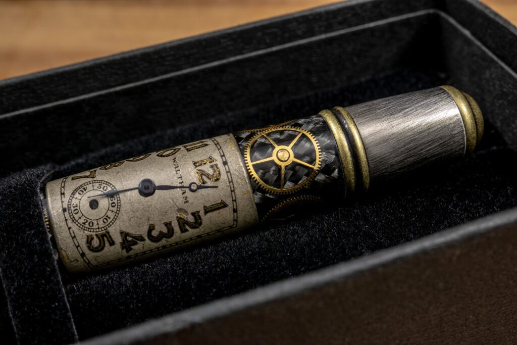 Close-up image of a hand turned Monarch Grande featuring antique Waltham watch part pens. 